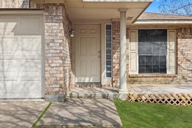 doorway to property featuring brick siding