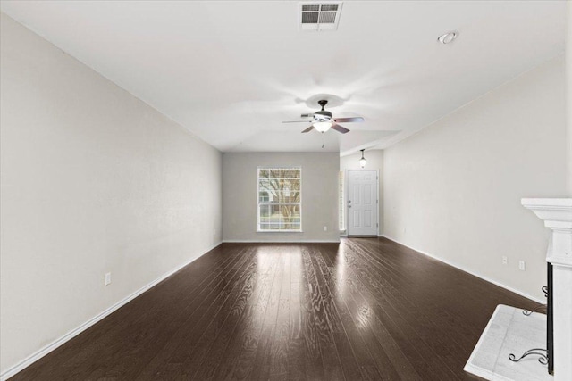 unfurnished living room with visible vents, a fireplace with flush hearth, a ceiling fan, wood finished floors, and baseboards