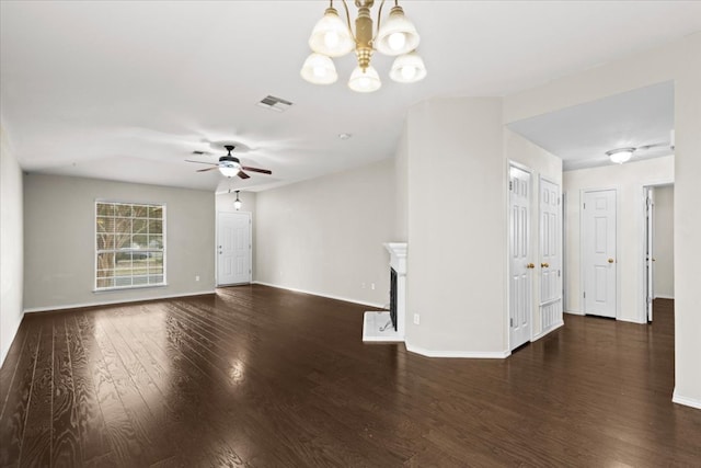 unfurnished living room featuring visible vents, baseboards, ceiling fan with notable chandelier, a fireplace, and wood finished floors