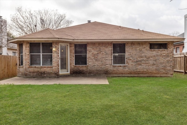 back of property featuring a yard, a patio, and fence