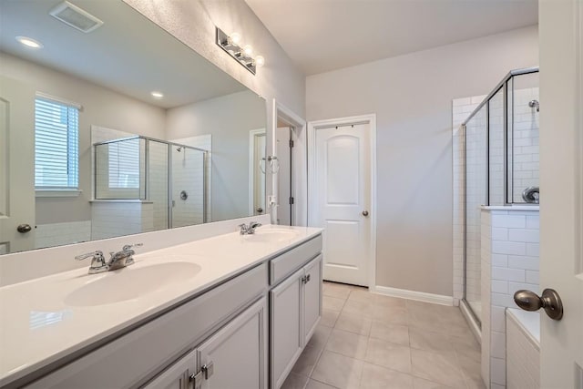 bathroom featuring a shower stall, tile patterned floors, and a sink