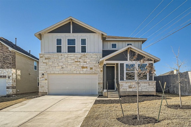 view of front of home with stone siding, board and batten siding, concrete driveway, and fence