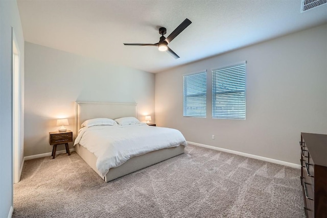 bedroom featuring a ceiling fan, baseboards, visible vents, and carpet floors