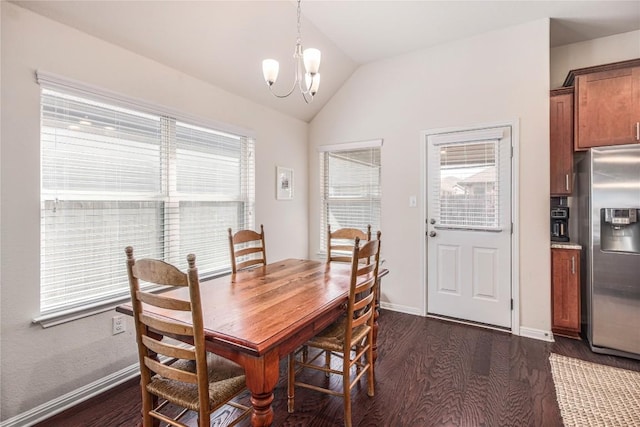 dining space with a notable chandelier, dark wood-type flooring, baseboards, and vaulted ceiling