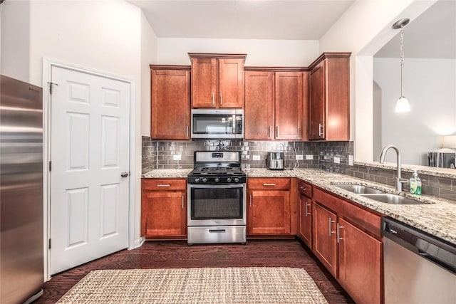 kitchen with backsplash, light stone countertops, stainless steel appliances, and a sink