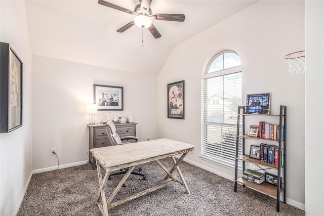 carpeted home office with baseboards, ceiling fan, and vaulted ceiling