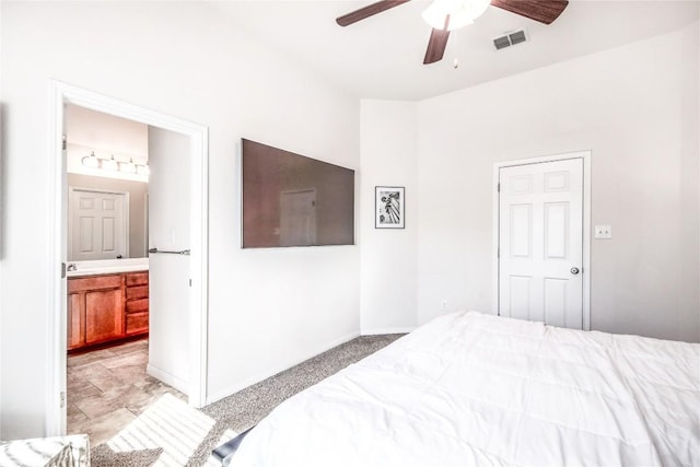 bedroom with ceiling fan, baseboards, visible vents, and connected bathroom