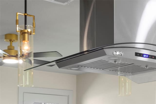 details featuring wall chimney exhaust hood