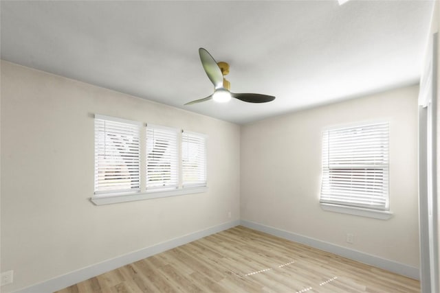 unfurnished room featuring a ceiling fan, baseboards, and light wood finished floors