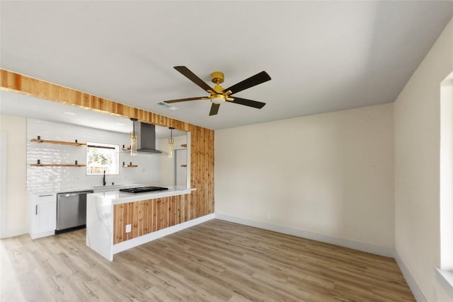 kitchen with wall chimney range hood, light wood-type flooring, stainless steel dishwasher, gas stovetop, and open shelves