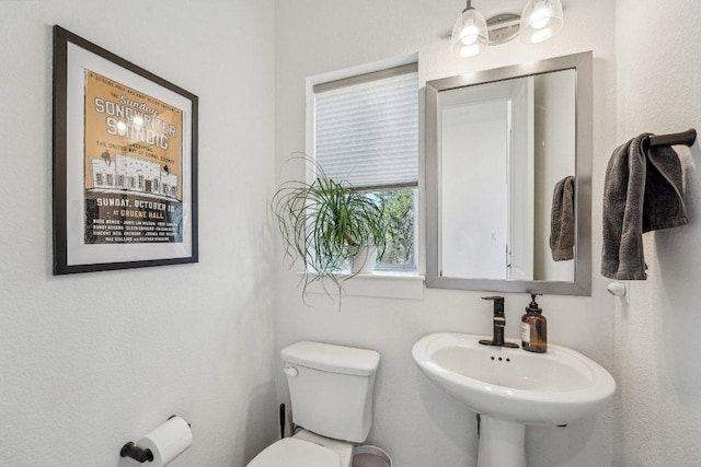 half bathroom with a sink and toilet