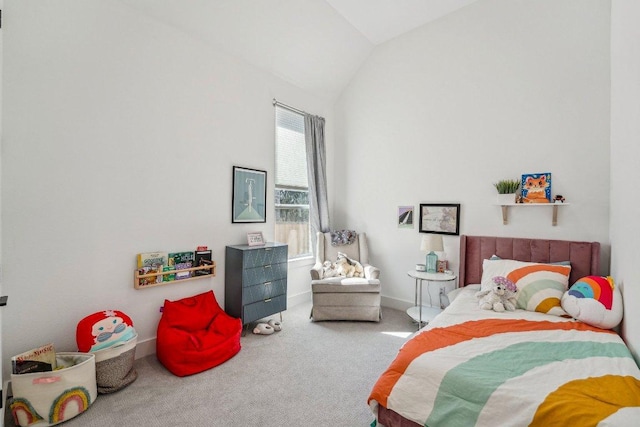 carpeted bedroom with baseboards and vaulted ceiling