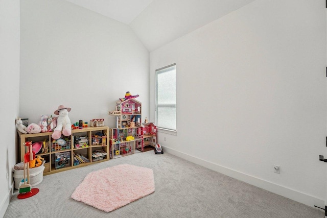 recreation room featuring baseboards, lofted ceiling, and carpet floors