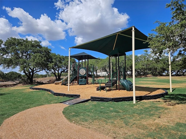 community jungle gym featuring a lawn