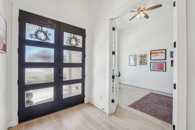 entryway featuring plenty of natural light, light wood-style floors, baseboards, and french doors