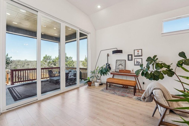 living area featuring light wood finished floors, recessed lighting, and lofted ceiling