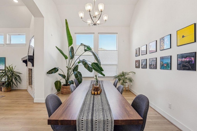 dining room with plenty of natural light, light wood-type flooring, and baseboards