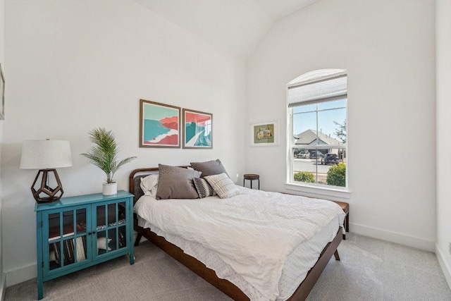 bedroom with baseboards, carpet floors, and high vaulted ceiling