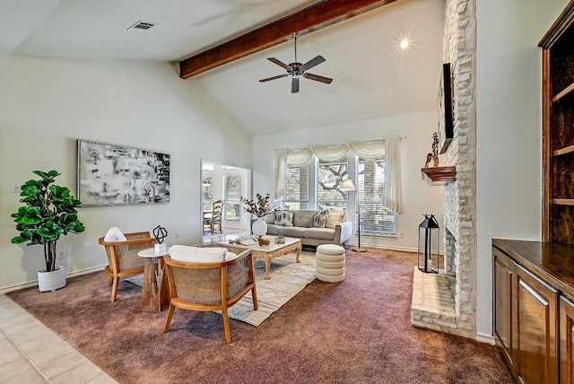 living area featuring visible vents, ceiling fan, beam ceiling, a stone fireplace, and high vaulted ceiling