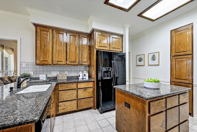410 Rolling Green Dr, Lakeway, TX 78734 - kitchen featuring black appliances, crown molding, a sink, dark stone counters, and light tile patterned floors