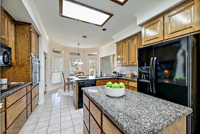 410 Rolling Green Dr, Lakeway, TX 78734 - kitchen featuring black appliances, a peninsula, dark stone counters, tasteful backsplash, and light tile patterned floors
