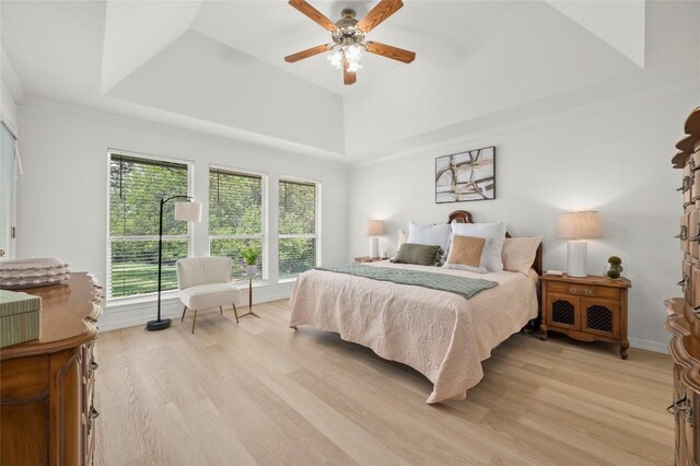 410 Rolling Green Dr, Lakeway, TX 78734 - bedroom featuring light wood-type flooring, a raised ceiling, and a ceiling fan