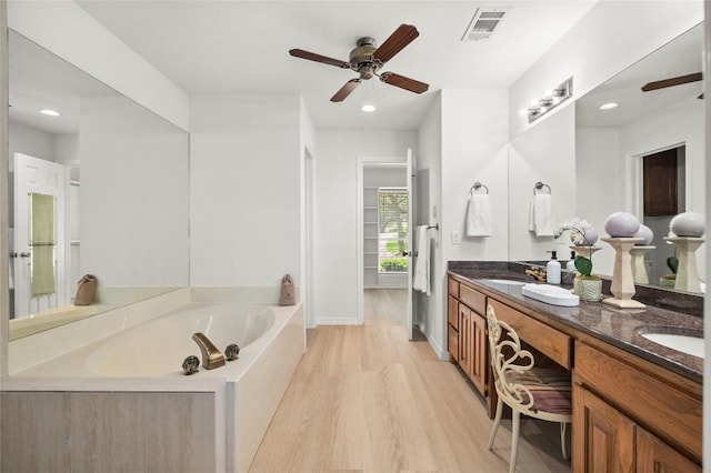 410 Rolling Green Dr, Lakeway, TX 78734 - full bathroom with a ceiling fan, wood finished floors, a bath, double vanity, and recessed lighting