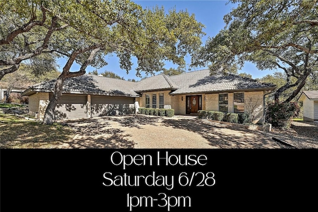 410 Rolling Green Dr, Lakeway, TX 78734 - view of front of home featuring a garage, a tiled roof, and dirt driveway