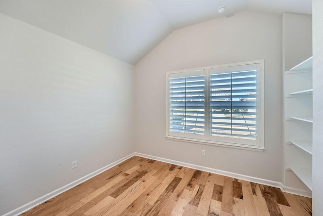 107 Lemuel Crawford Trl, Bastrop, TX 78602 - spare room with lofted ceiling, light wood finished floors, baseboards, and a smoke detector