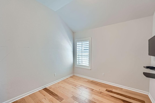 107 Lemuel Crawford Trl, Bastrop, TX 78602 - empty room featuring light wood-type flooring, vaulted ceiling, and baseboards