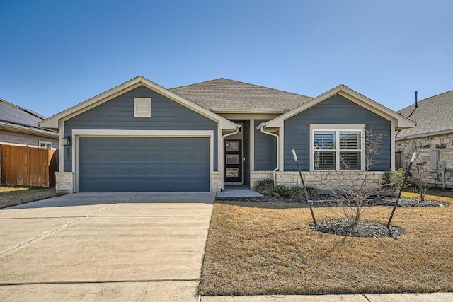 107 Lemuel Crawford Trl, Bastrop, TX 78602 - view of front of home featuring an attached garage, concrete driveway, and stone siding