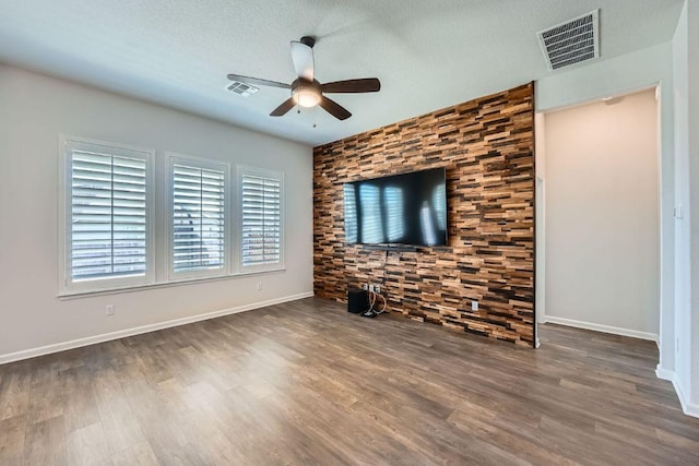 107 Lemuel Crawford Trl, Bastrop, TX 78602 - unfurnished living room featuring a ceiling fan, wood finished floors, and a textured ceiling