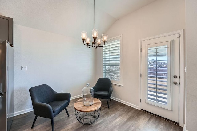 107 Lemuel Crawford Trl, Bastrop, TX 78602 - sitting room featuring a chandelier, lofted ceiling, wood finished floors, and baseboards