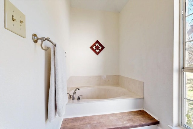 bathroom with a garden tub