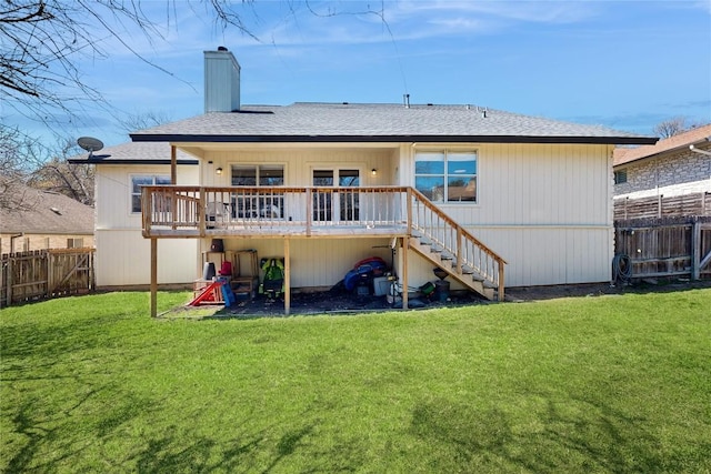 rear view of property with a wooden deck, a fenced backyard, a chimney, stairs, and a lawn