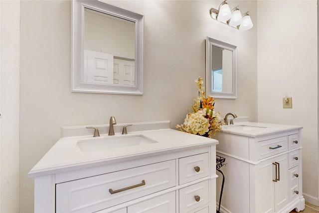 bathroom with two vanities and a sink