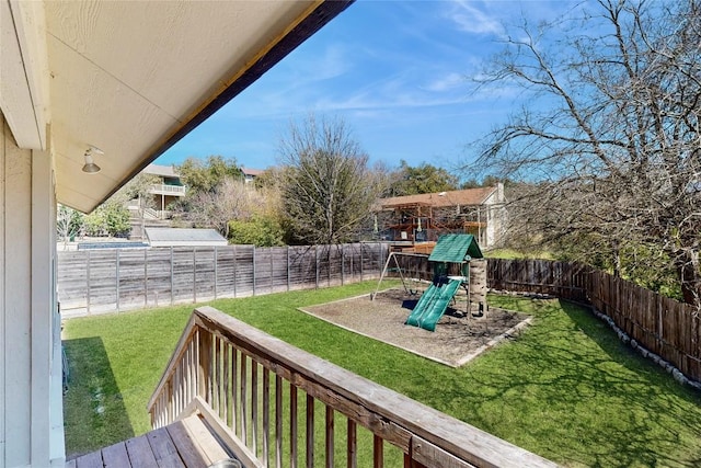 view of yard featuring a fenced backyard and a playground