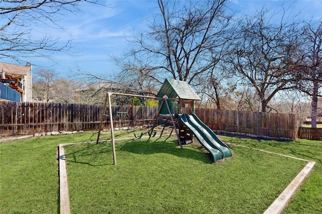 view of jungle gym with a yard and a fenced backyard