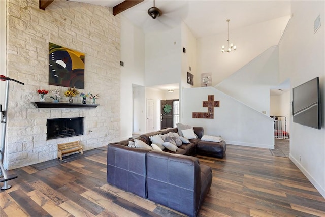 living room with wood finished floors, baseboards, a fireplace, stairs, and a chandelier