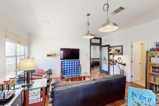 living room with visible vents, wood finished floors, recessed lighting, baseboards, and lofted ceiling