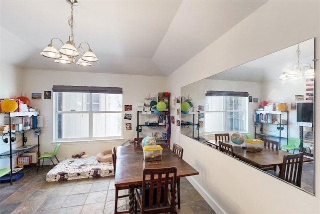 dining area with baseboards, a chandelier, and vaulted ceiling