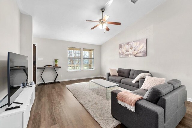 living room with ceiling fan, baseboards, dark wood finished floors, and vaulted ceiling