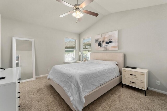 bedroom with vaulted ceiling, carpet flooring, a ceiling fan, and baseboards