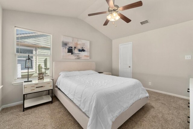 bedroom featuring vaulted ceiling, baseboards, visible vents, and light carpet