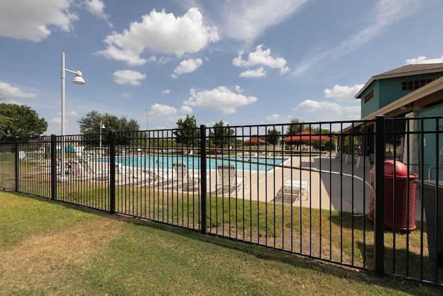 pool featuring a yard, central AC unit, and fence