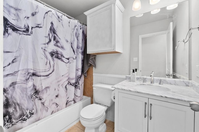 bathroom featuring tile patterned floors, toilet, shower / bath combo, and vanity