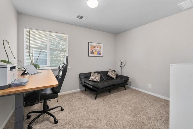 home office with visible vents, baseboards, and carpet flooring