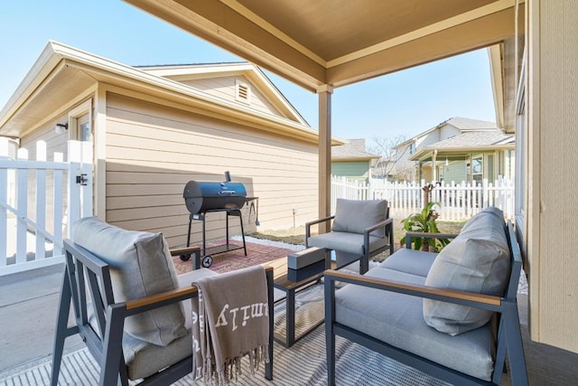 view of patio with grilling area, an outdoor living space, and fence