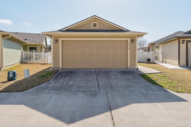 view of front facade featuring a garage, an outbuilding, and fence