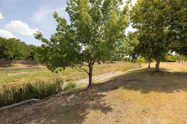 view of yard with a rural view and fence